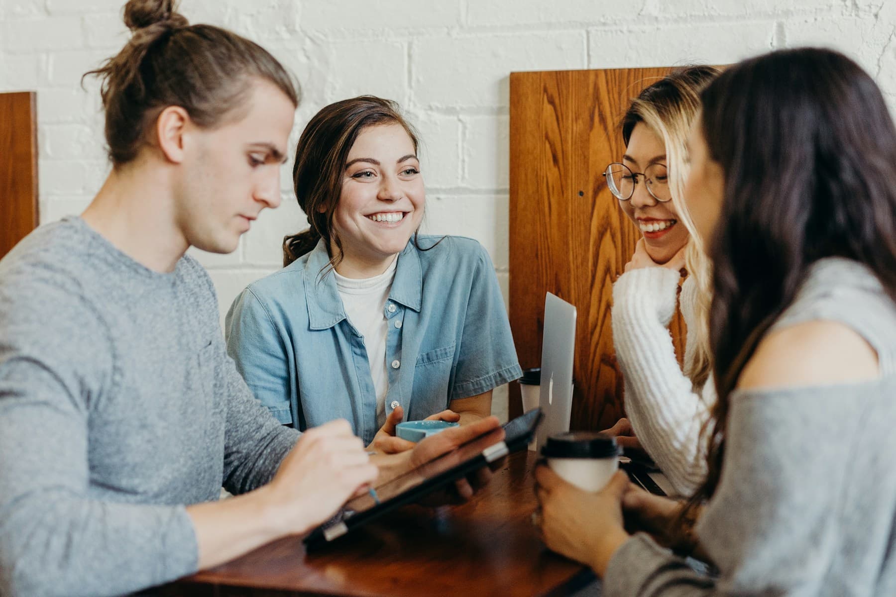 Four friends at a café table